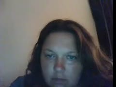 On livecam, a chubby, dark-brown, sultry wife tries to attract attention.